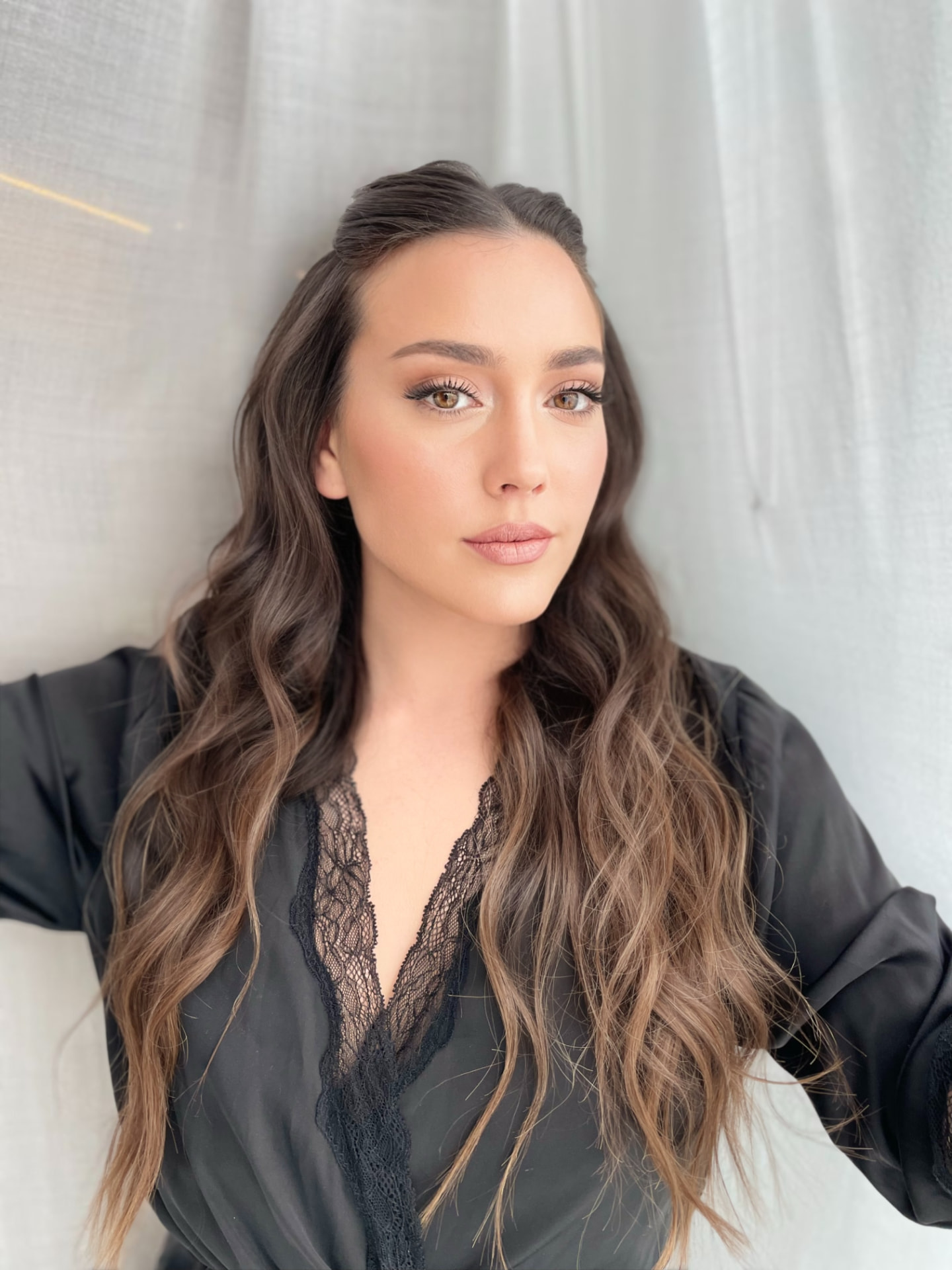 Bridal look by Lee Elrom — half-up half-down wavy style with soft glam and winged eyeliner